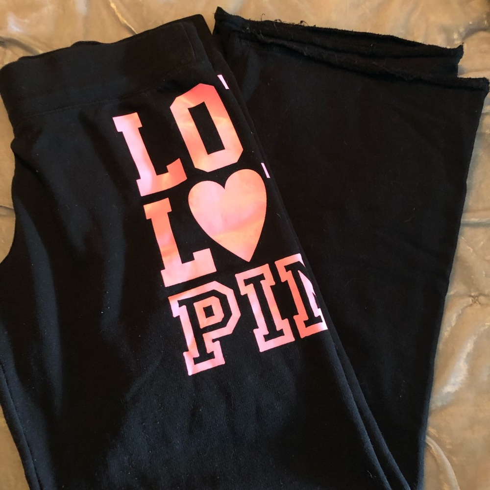Pink- black sweatpants with hot pink lettering.